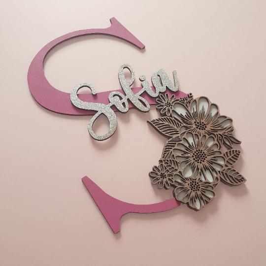 Large letter background with name and intricate dual layer floral pattern foreground. All laser cut, painted to colours of your choice and bonded together.