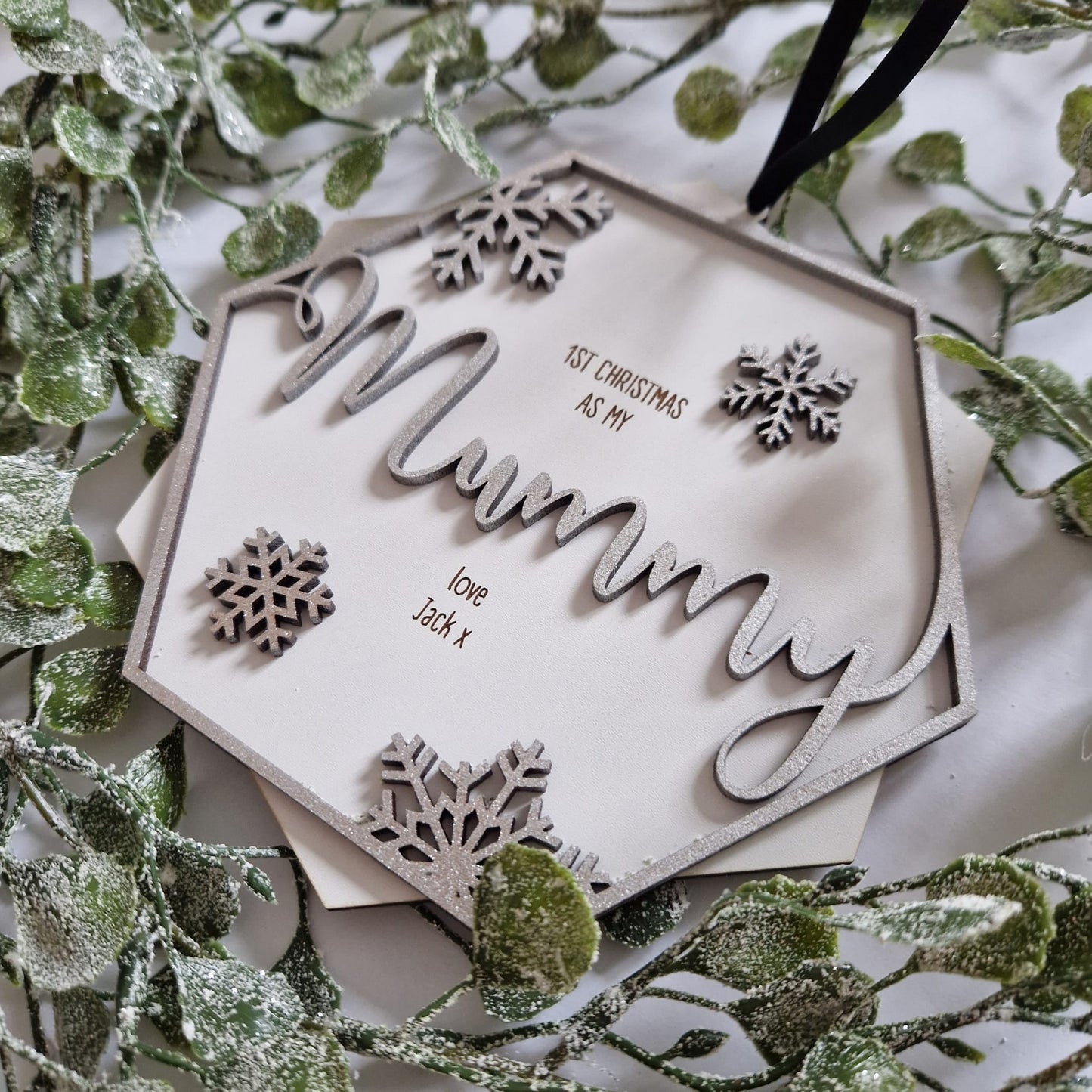 Beautiful 2 layered wooden hanging gift. Laser cut with the word Mummy on the top layer complete with snowflake designs and engraved with a personal message from you on the bottom layer.